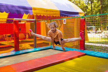 Fototapeta na wymiar The joyful children are jumping in the trampoline park
