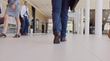 Businessman walking in office hallway