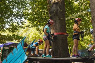 The children in helmets are preparing for the descent