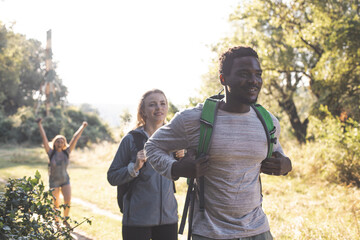 The young people are having fun while walking in the forest