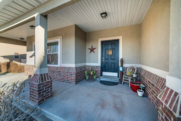 Porch with decorative front door and concrete flooring