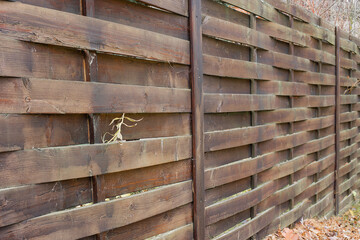 An old wooden, wicker fence.