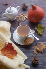 Autumn composition with a white mug and green tea on a wooden table