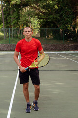 man in red sportwear playing tennis