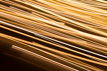 illumination and backgrounds concept - golden electric light effect lines on dark background