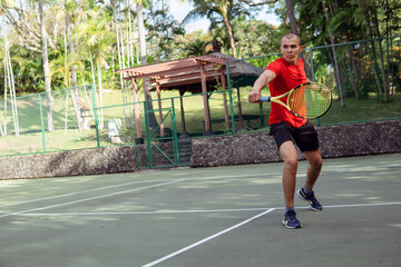 man in red sportwear playing tennis