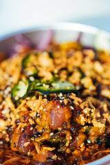 Poke bowl with salmon or tuna, avocado, beans and lot of different ingredients ready for take out