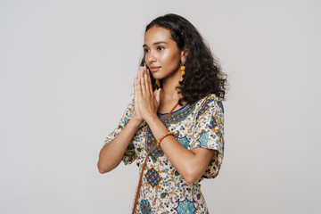 Young south asian woman wearing dress posing with palms together