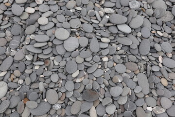 organic shapes of grat rocks on the beach design for material textured background