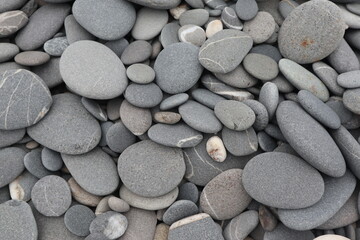 organic shapes of grat rocks on the beach design for material textured background