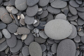 Fototapeta na wymiar organic shapes of grat rocks on the beach design for material textured background