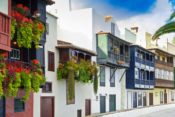 Old houses with historic wooden balconies in different colors, tourist attraction of Santa Cruz de La Palma, Canary Islands, in winter.