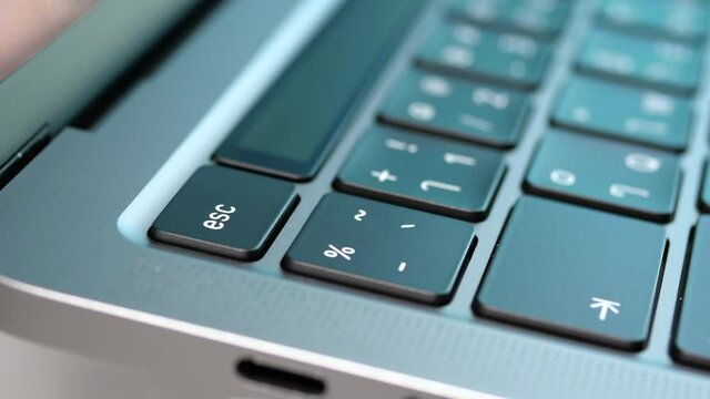 Close up rotation movement of USB type c port for connection in laptop with blur Thai keyboard