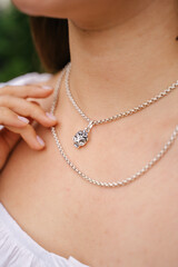 Close-up of a female jewelry on a girl's neck, a beautiful silver necklace