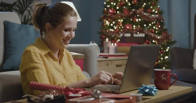 Woman sending Christmas wishes online