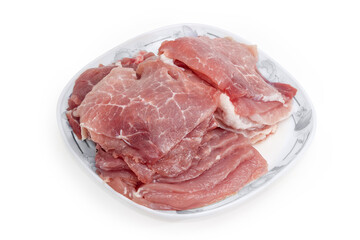 Sliced uncooked pork pulp on dish on white background