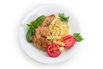 Small meat roulades with spiral pasta and tomatoes on dish