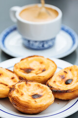 Obraz na płótnie Canvas Egg custard tarts called Pasteis de Nata with two coffees 
