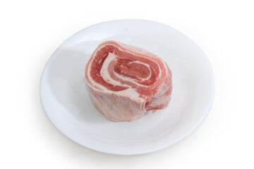 Roll of frozen raw streaky pork belly on white dish