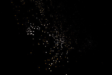 Golden abstract bokeh on black background.