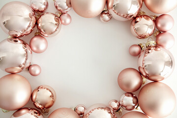 Pink Christmas baubles decoration on white background with copy space. Merry Christmas and Happy New Year greeting card. Minimal style. Flat lay, top view.