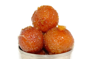 close up of indian dessert or sweet gulab jamun in a glass bowl isolated on white background.