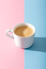 cup of coffee on a pastel pink background, photography with contrast shadow, selective focus