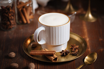 A cup of pumpkin spice latte or salep in a rustic wooden autumn atmosphere
