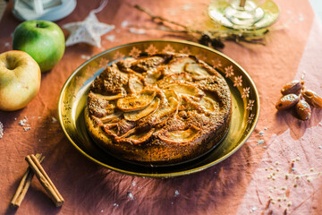 close up of an apple cake with natural light served in a golden tray