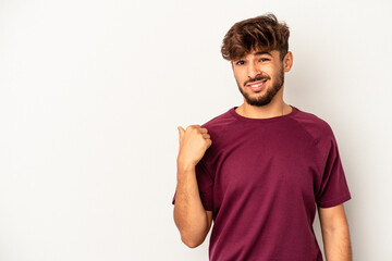 Young mixed race man isolated on grey background shocked pointing with index fingers to a copy space.