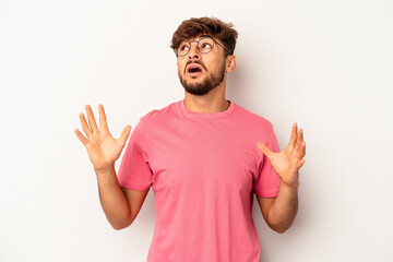 Fototapeta premium Young mixed race man isolated on grey background screaming to the sky, looking up, frustrated.