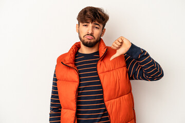 Young mixed race man isolated on grey background showing a dislike gesture, thumbs down....