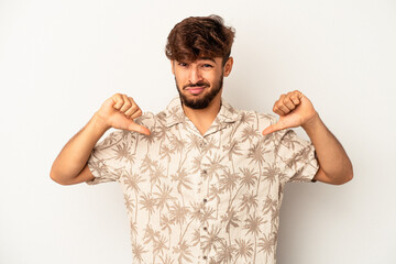 Young mixed race man isolated on grey background showing thumb down, disappointment concept.