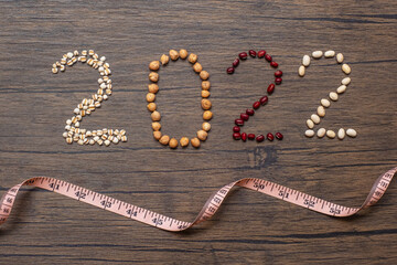 2022 New Year with organic Beans; red, black, white, green, chickpeas and Adlay on table. Goals, Healthy, Motivation, Resolution, Weight loss, dieting and world food day concept