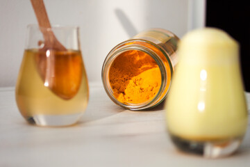 Glass with turmeric powder with honey. Healthy ayurvedic drink, detox beverage. Copy spase.