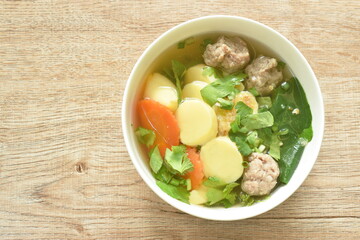 boiled vegetable gourd chop pork and carrot with egg tofu soup on bowl