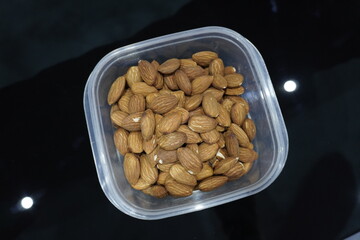 Pile of almonds seeds in plastic casserole