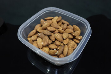 Pile of almonds seeds in plastic casserole