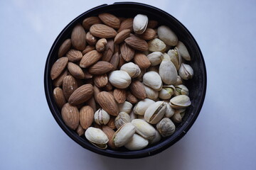 Almonds and pistachio close up white background
