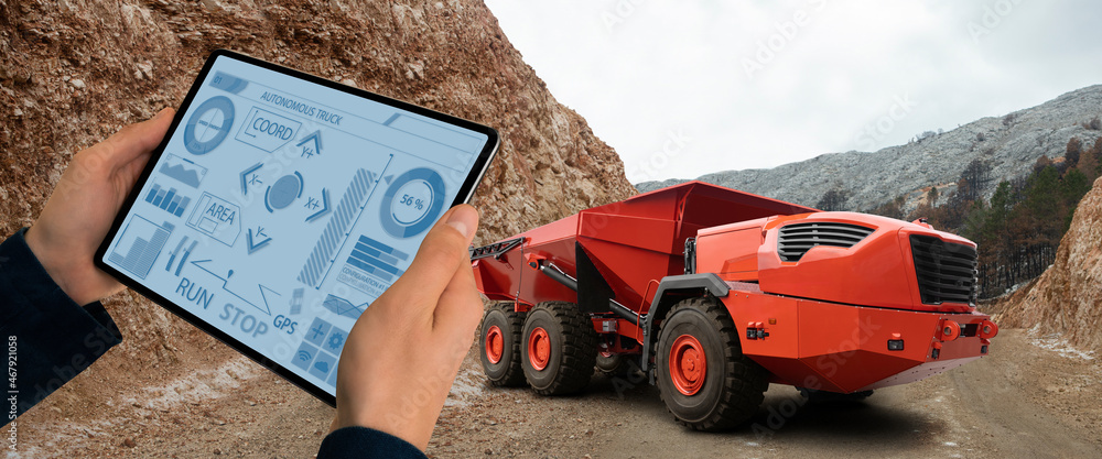 Poster Man controls autonomous mining truck using digital tablet