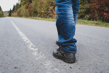 Man walking down on a forest road.
