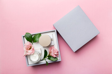 Composition with cosmetic products and beautiful roses on color background. Flat lay