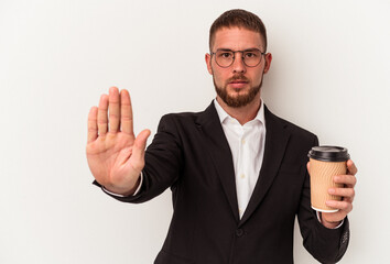 Young business caucasian man holding take away coffee isolated on white background standing with outstretched hand showing stop sign, preventing you.