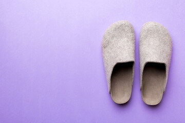Warm winter women woolen slippers on colored background. Copy space for text