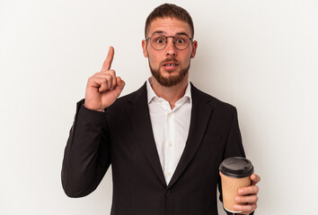 Young business caucasian man holding take away coffee isolated on white background having an idea, inspiration concept.