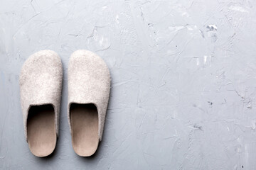 Warm winter women woolen slippers on the floor. Copy space for text