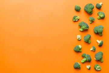 Top view fresh green broccoli vegetable on Colored background. Broccoli cabbage head Healthy or vegetarian food concept. Flat lay. Copy space