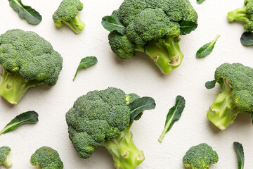 green fresh broccoli background close up on colored table. Vegetables for diet and healthy eating....