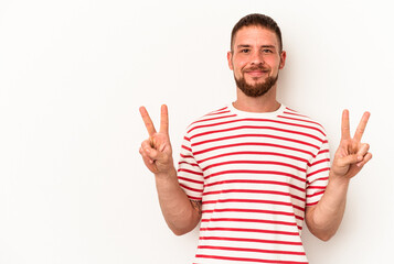 Young caucasian man with diastema isolated on white background showing victory sign and smiling broadly.