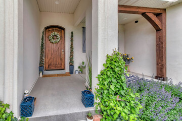 Front porch with craftsman design and ornamental plants
